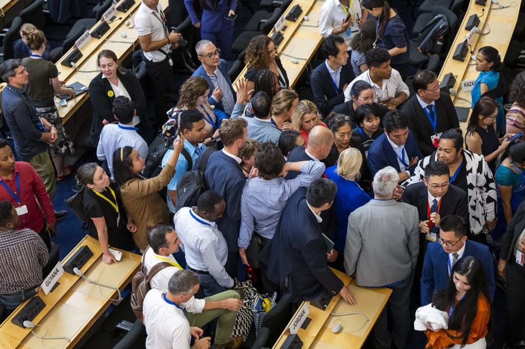 Delegates at the European headquarters of the UN in Geneva react on Thursday as talks on a plastic pollution treaty extend into an unscheduled eleventh day. Photo: EPA