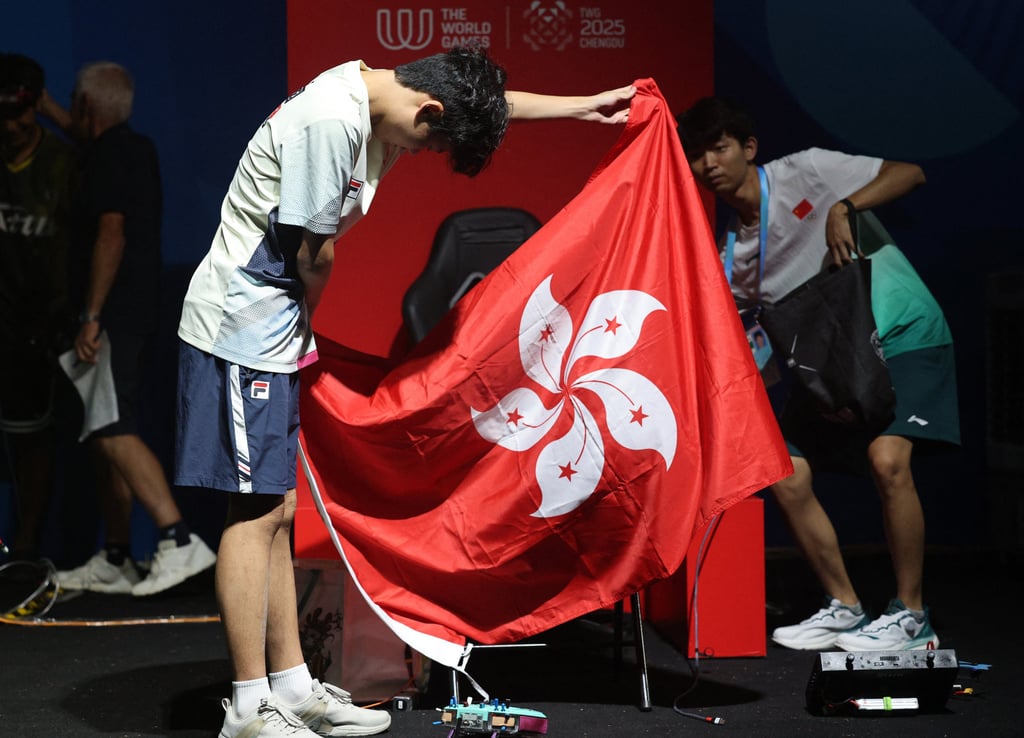 Kwan Chun-yan with the Hong Kong flag after his silver medal finish. Photo: Reuters Kwan Chun-yan with the Hong Kong flag after his silver medal finish. Photo: Reuters