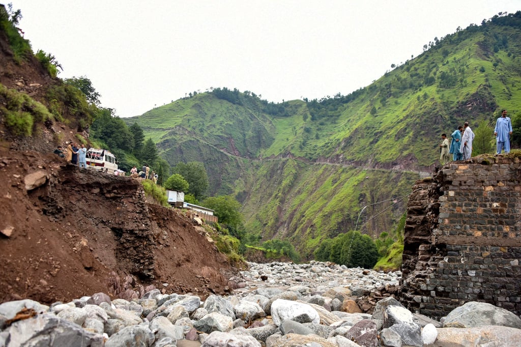 Onlookers gather near a destroyed bridge after flash floods on the outskirts of Muzaffarabad, the capital of Pakistan-administered Kashmir. Photo: TNS Onlookers gather near a destroyed bridge after flash floods on the outskirts of Muzaffarabad, the capital of Pakistan-administered Kashmir. Photo: TNS