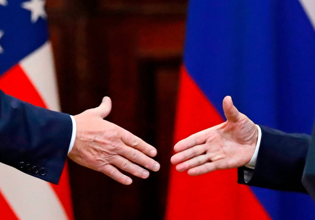 Donald Trump and Russia’s Vladimir Putin go to shake hands after a press conference in 2018. Photo: AP