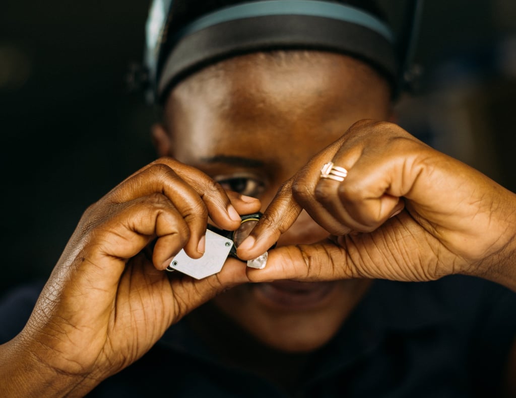 A De Beers employee in Botswana sorts through rough diamonds with a loupe. Photo: Handout A De Beers employee in Botswana sorts through rough diamonds with a loupe. Photo: Handout