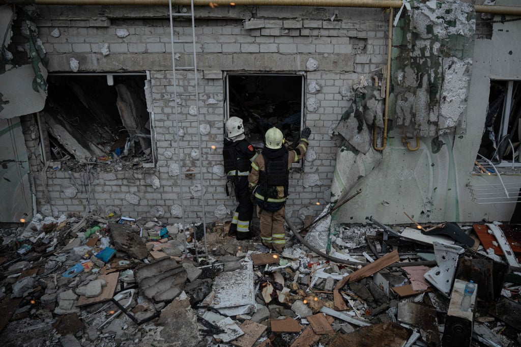 Ukrainian rescuers check a destroyed residential building after an air attack in Kharkiv, on Monday. Photo: AFP