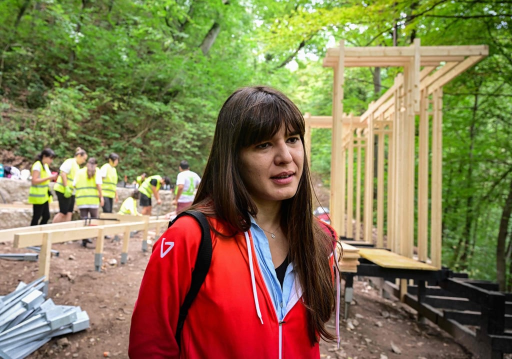 Architect Oana Chirila, 31, stands next to a reconstruction site of The Countess’ Promenade and the Spring of Countess in Baile Herculane on July 29. Photo: AFP