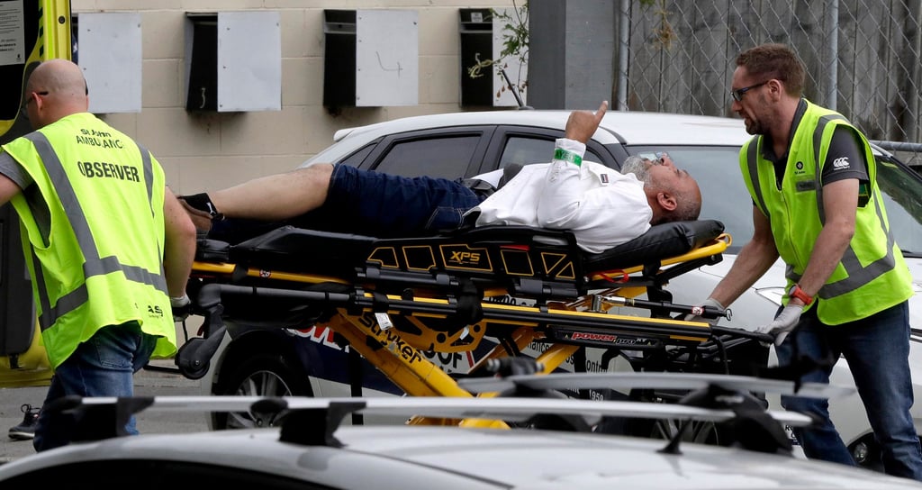 Ambulance staff ferry an injured man from a mosque in central Christchurch after the attacks on March 15, 2019. Photo: AP Ambulance staff ferry an injured man from a mosque in central Christchurch after the attacks on March 15, 2019. Photo: AP