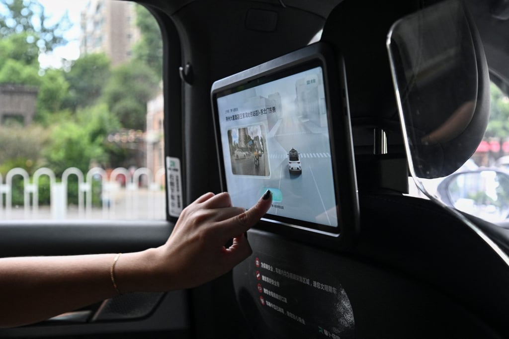 A person using a driverless taxi developed as part of tech giant Baidu’s Apollo Go self-driving project, in Wuhan, in central China’s Hubei province. Photo: AFP A person using a driverless taxi developed as part of tech giant Baidu’s Apollo Go self-driving project, in Wuhan, in central China’s Hubei province. Photo: AFP