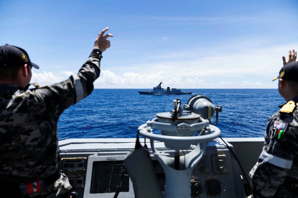 Australian troops gesture as Philippine frigate BRP Jose Rizal sails past the Australian destroyer HMAS Brisbane during Exercise Alon earlier this month. Photo: Australia’s Defence Department