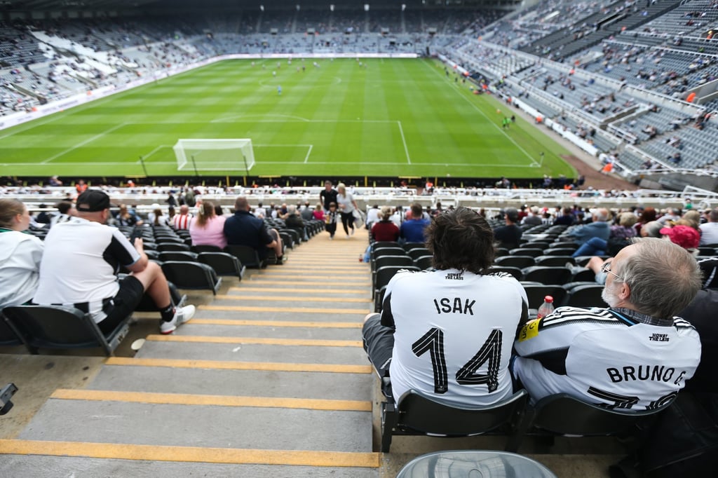 A Newcastle United fan watches a pre-season friendly between the Premier League side and Newcastle United Women and Atletico Madrid. Photo: EPA