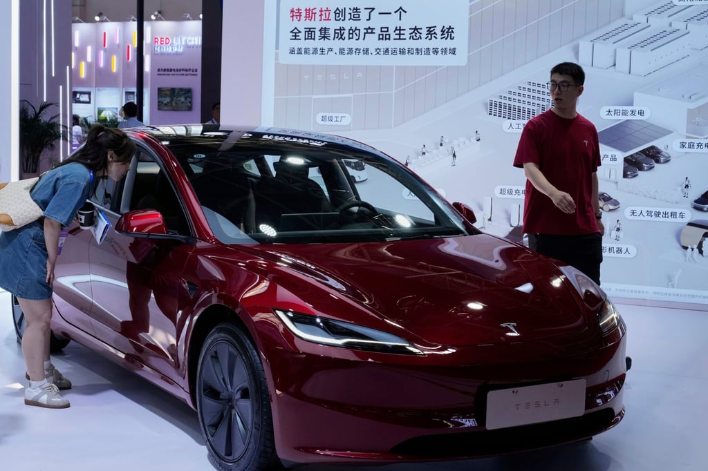 A woman views a Tesla Model 3 during the third China International Supply Chain Expo at the China International Exhibition Centre, in Beijing on July 18. Photo: AP Photo
