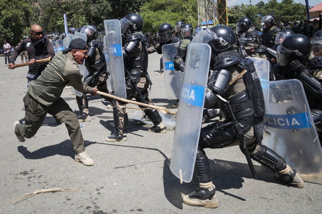Members of East Timor’s Special Police Unit demonstrate anti-riot capabilities during a ceremony marking the unit’s 16th anniversary in Dili on August 14. Photo: AFP