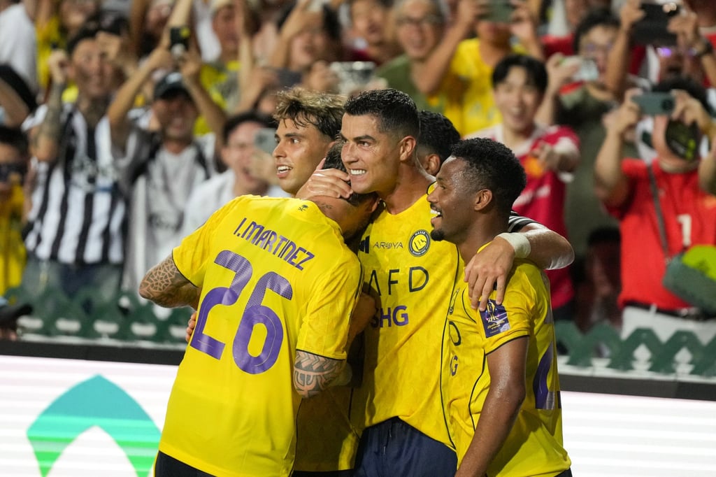 Al-Nassr’s Cristiano Ronaldo celebrates his opener with teammates. Photo: Elson Li