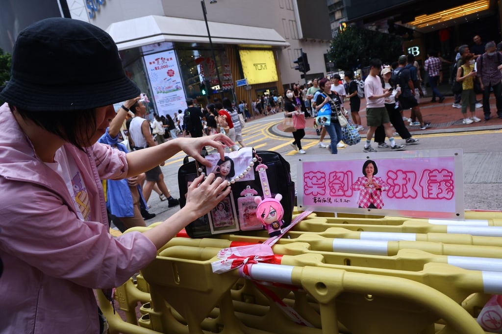A fan shows off themed Regina Ip accessories, including a glasses cloth souvenir received at the birthday event. Photo: Dickson Lee