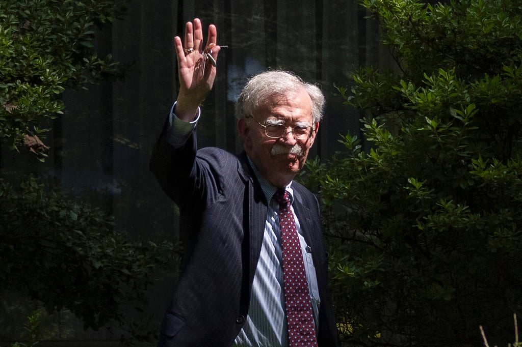 Former US national security adviser John Bolton waves as he arrives at his house in Bethesda, Maryland, on Friday. Photo: AP Former US national security adviser John Bolton waves as he arrives at his house in Bethesda, Maryland, on Friday. Photo: AP