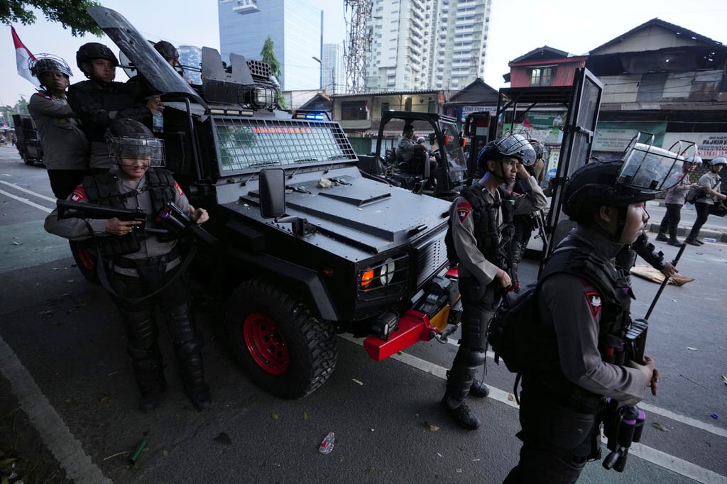 Riot police officers take their position during a protest in Jakarta, Indonesia on Monday. Photo: AP Riot police officers take their position during a protest in Jakarta, Indonesia on Monday. Photo: AP