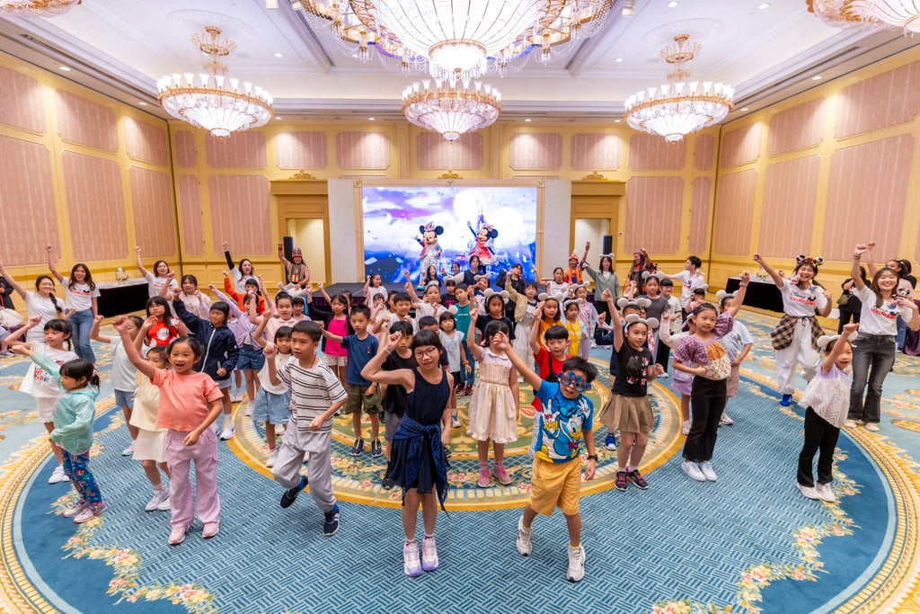 Children learn dance moves with help from Disney VoluntEars during a dance party held at Hong Kong Disneyland to mark the resort’s 20th anniversary celebrations. Children learn dance moves with help from Disney VoluntEars during a dance party held at Hong Kong Disneyland to mark the resort’s 20th anniversary celebrations.