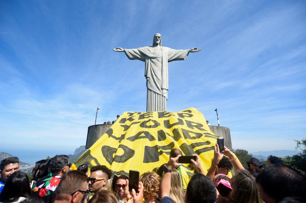 People in Rio de Janeiro holding a ‘Trump keep your hands off Brazil’ banner took part in a protest on Saturday against the imposition of US tariffs on Brazilian products. Photo: Reuters People in Rio de Janeiro holding a ‘Trump keep your hands off Brazil’ banner took part in a protest on Saturday against the imposition of US tariffs on Brazilian products. Photo: Reuters