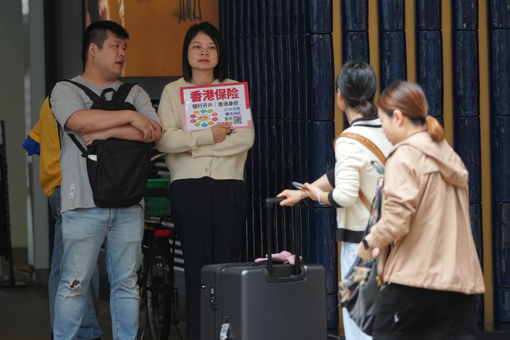 Insurance sales agents approach mainland tourists in Canton Road, Tsim Sha Tsui. Photo: Eugene Lee Insurance sales agents approach mainland tourists in Canton Road, Tsim Sha Tsui. Photo: Eugene Lee