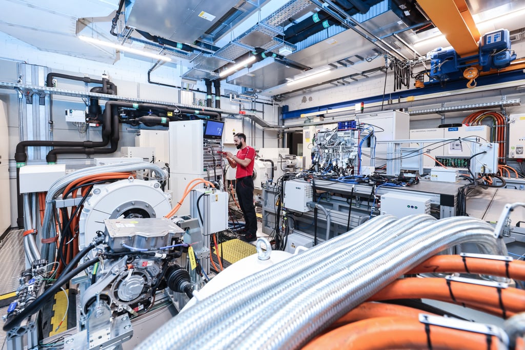 A Porsche engineer monitors battery diagnostics and thermal systems during EV testing in Weissach, Germany. Photo: Porsche