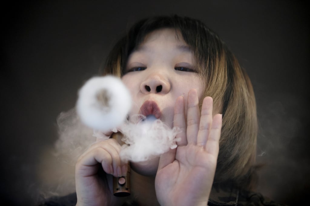A saleswoman in Beijing, China uses a vaping product. Singapore banned the purchase, possession and use of vapes in 2018, and will toughen those laws from next month. Photo: Reuters A saleswoman in Beijing, China uses a vaping product. Singapore banned the purchase, possession and use of vapes in 2018, and will toughen those laws from next month. Photo: Reuters