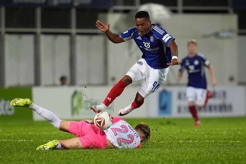 Gil Martins hurdles prostrate Kitchee left-back Callum Beattie. Photo: Elson Li