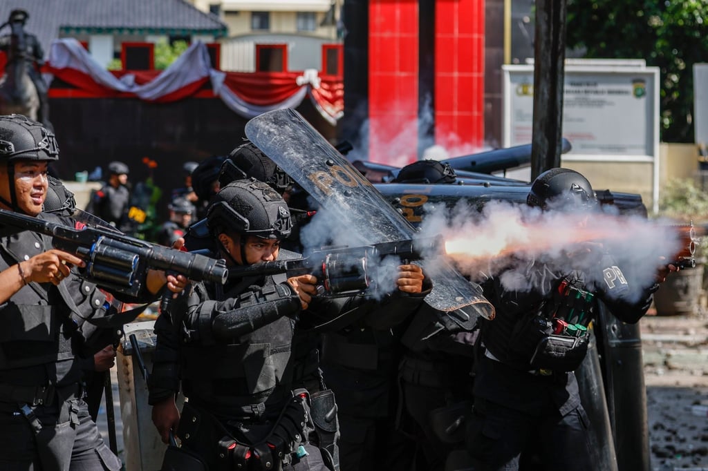 Police fire tear gas during a protest in Jakarta on Friday. Photo: EPA