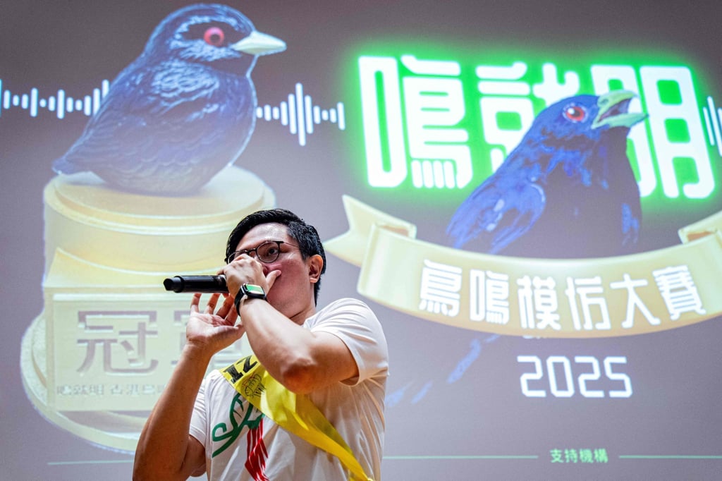Bob Chan, the gold award winner, imitates bird calls during the Hong Kong Bird Watching Society’s bird call competition at the University of Hong Kong, on August 23. Photo: AFP