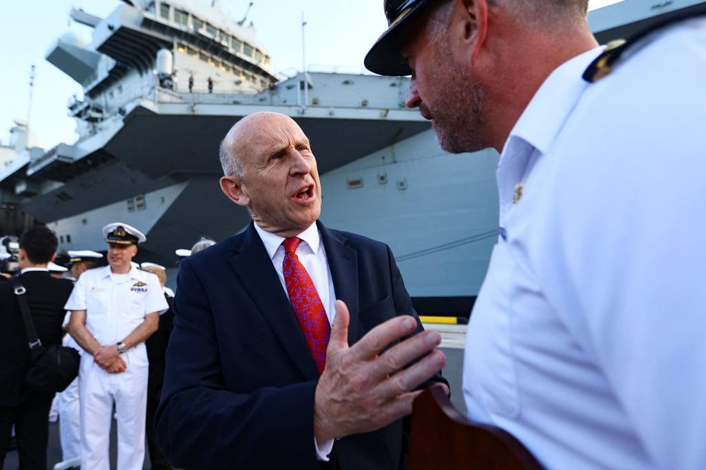 British Defence Secretary John Healey (centre) talks with Captain Will Blackett of the HMS Prince of Wales in Tokyo on Thursday. Photo: Reuters