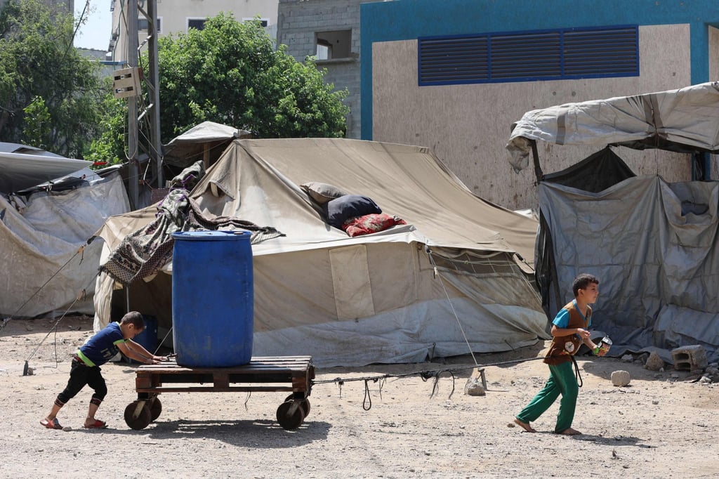 Palestinian boys transport a plastic container in the Sheikh Radwan neighbourhood of Gaza City last month. Photo: AFP Palestinian boys transport a plastic container in the Sheikh Radwan neighbourhood of Gaza City last month. Photo: AFP