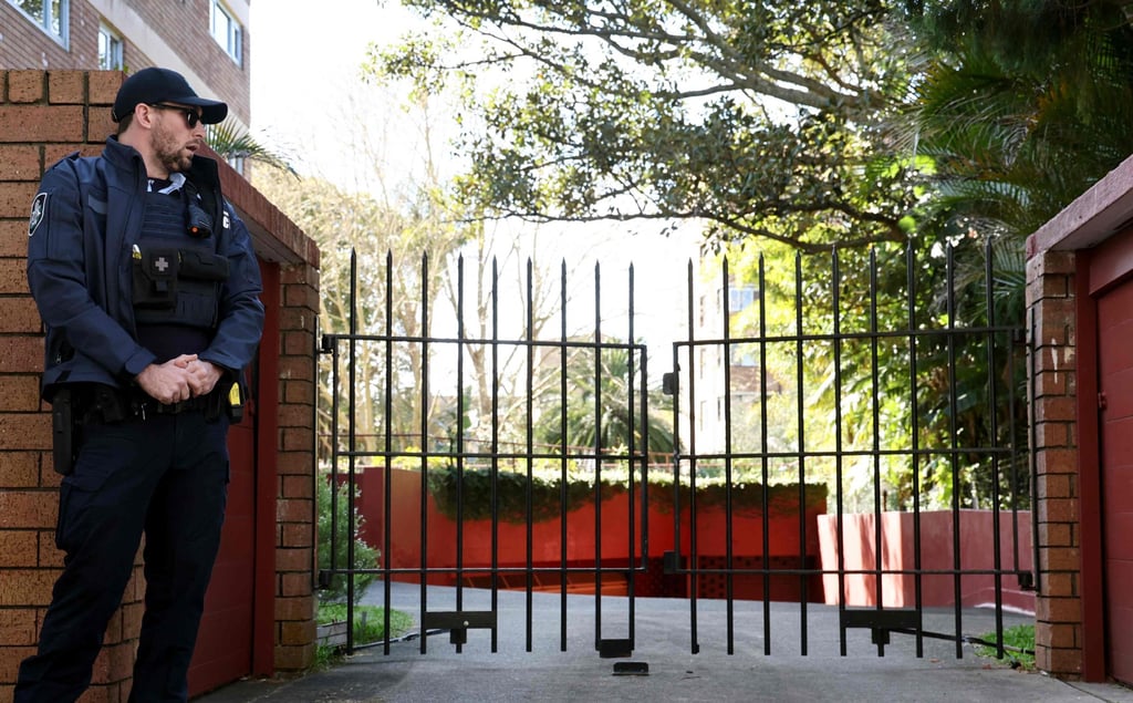 A police officer stands guard outside the gates of the Russian consulate in Sydney on Monday. Photo: AFP A police officer stands guard outside the gates of the Russian consulate in Sydney on Monday. Photo: AFP
