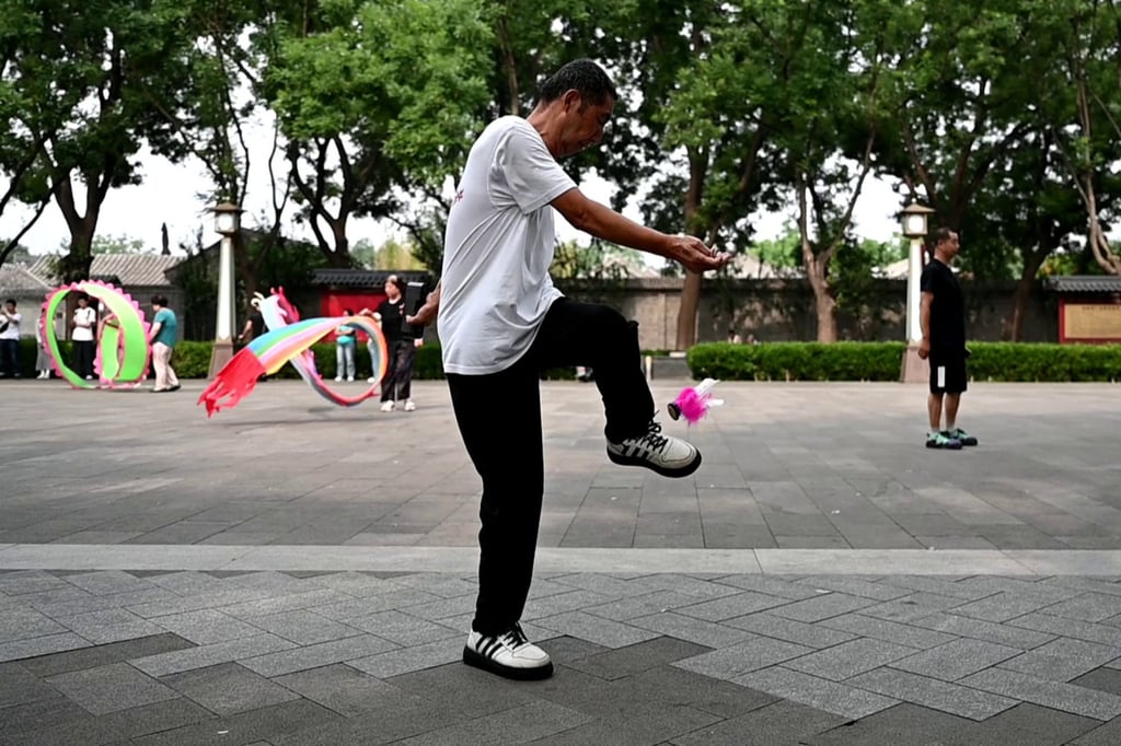 Lao Fan keeps a jianzi shuttlecock in the air using his foot. Photo: dpa