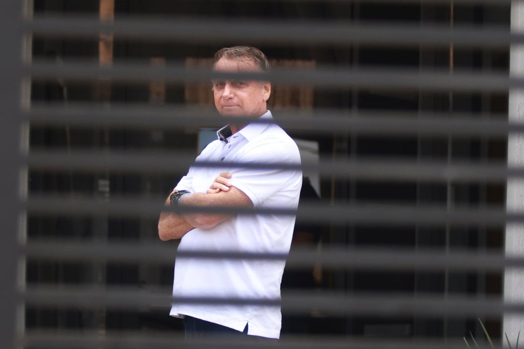 Brazil’s former president Jair Bolsonaro at the entrance of his home where he is under house arrest. Photo: AP Brazil’s former president Jair Bolsonaro at the entrance of his home where he is under house arrest. Photo: AP