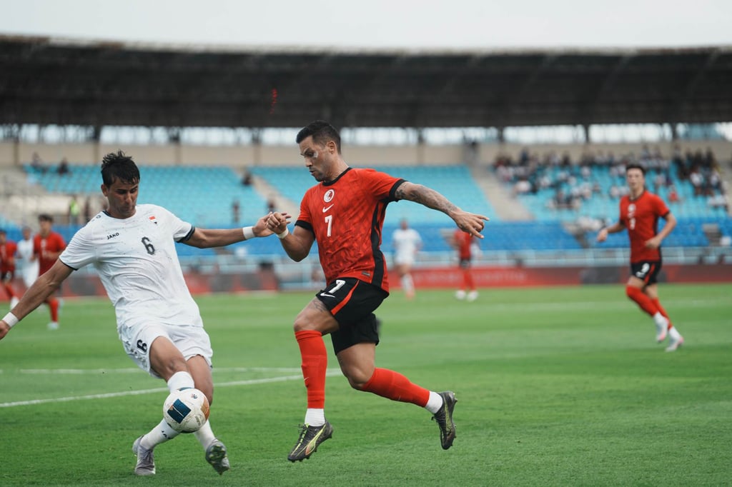Hong Kong forward Juninho challenges Iraq’s Munaf Younis at Kanchanaburi Stadium. Photo: HKFA