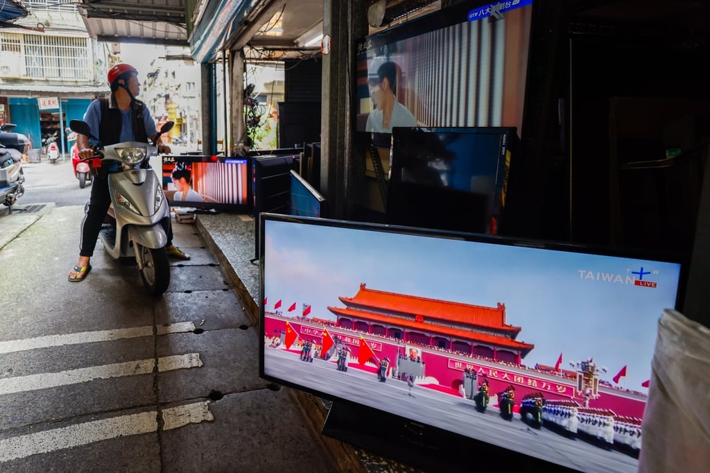A Television broadcast of the military parade in China is seen at a TV store as people pass by in Taipei, Taiwan, on Wednesday. Photo: EPA A Television broadcast of the military parade in China is seen at a TV store as people pass by in Taipei, Taiwan, on Wednesday. Photo: EPA