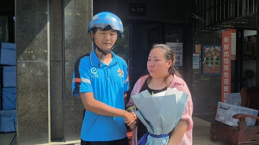 Deliver rider Liu Xu and a grateful Chen after she was freed from the freezer. Photo: Handout