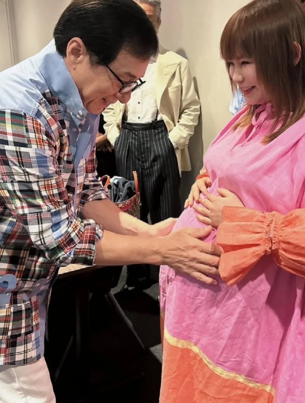 Kung fu legend Jackie Chan makes a dream come true as he gently touches Shoko Nakagawa’s baby bump. Photo: Handout