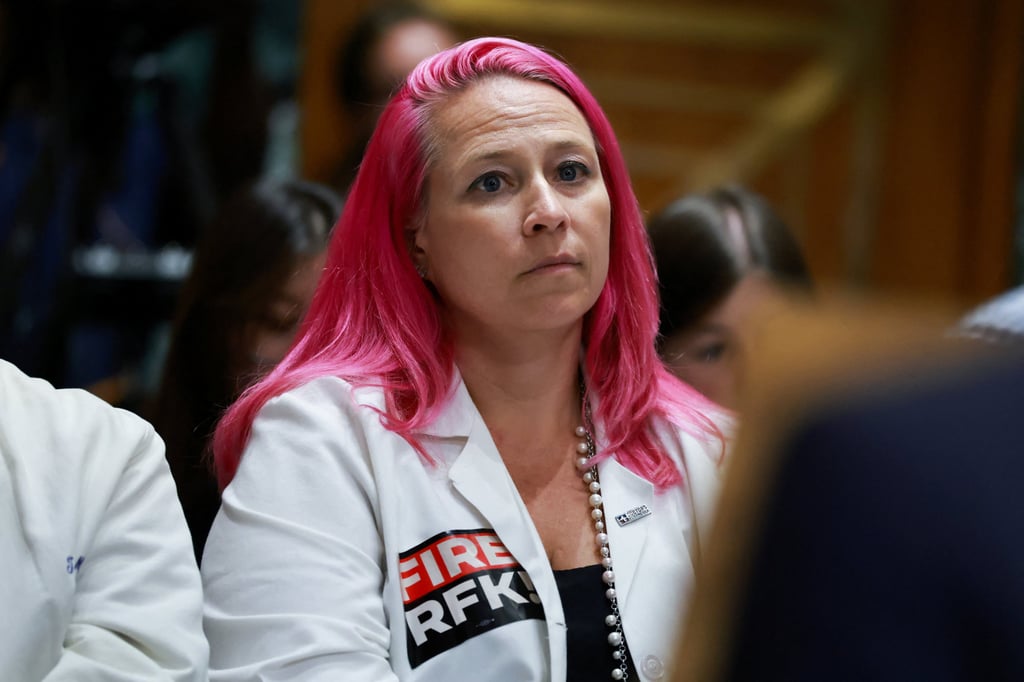 A member of “Doctors for America” wears a lab coat with a “Fire RFK” sticker, as US Health and Human Services Secretary Robert F. Kennedy Jnr testifies in Washington on Thursday. Photo: Reuters A member of “Doctors for America” wears a lab coat with a “Fire RFK” sticker, as US Health and Human Services Secretary Robert F. Kennedy Jnr testifies in Washington on Thursday. Photo: Reuters