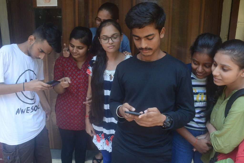 Students check their mobile phones in Thane, a city just outside Mumbai, India. Photo: Hindustan Times/Getty Images Students check their mobile phones in Thane, a city just outside Mumbai, India. Photo: Hindustan Times/Getty Images