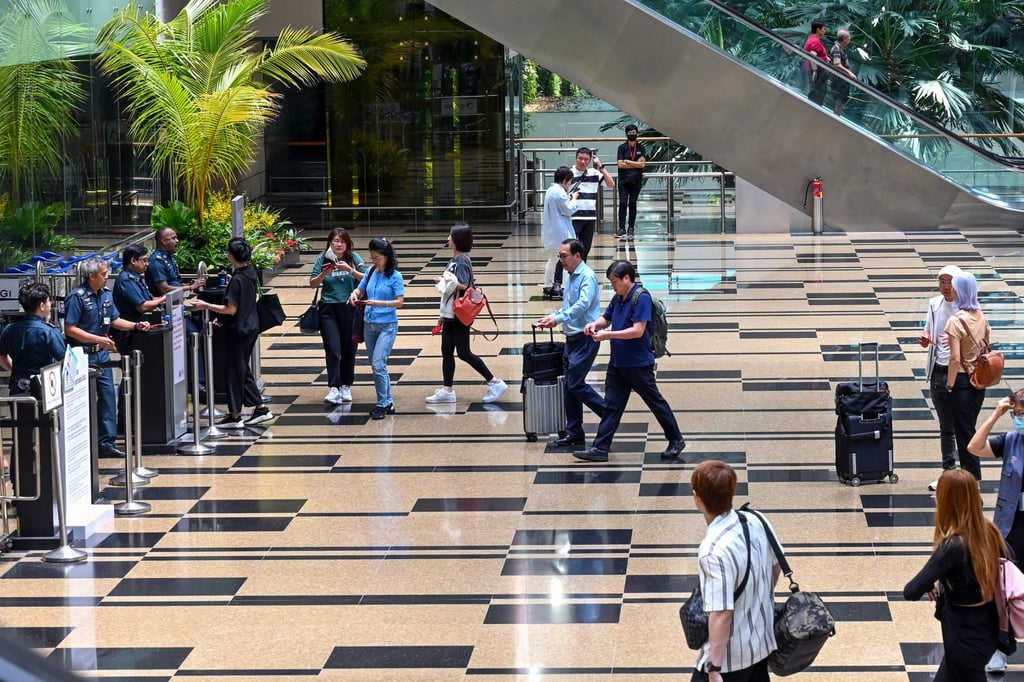 Passengers walk in the departure transit hall at Changi airport in Singapore in March 2024. Photo: AFP Passengers walk in the departure transit hall at Changi airport in Singapore in March 2024. Photo: AFP