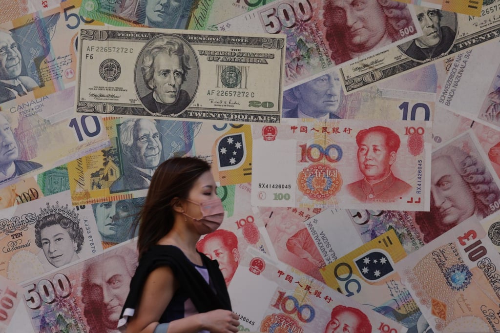 A pedestrian walks past a display of banknotes outside a currency exchange shop in Hong Kong, October 21, 2022. Photo: Yik Yeung -man A pedestrian walks past a display of banknotes outside a currency exchange shop in Hong Kong, October 21, 2022. Photo: Yik Yeung -man