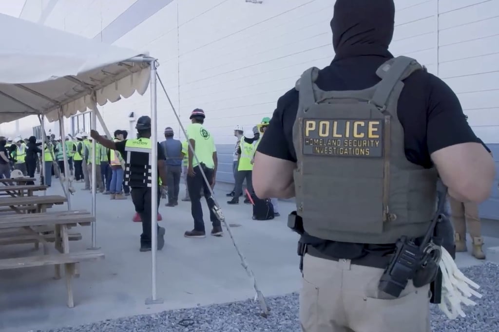 Workers being escorted on Thursday. Photo: US Immigration and Customs Enforcement via AP Workers being escorted on Thursday. Photo: US Immigration and Customs Enforcement via AP