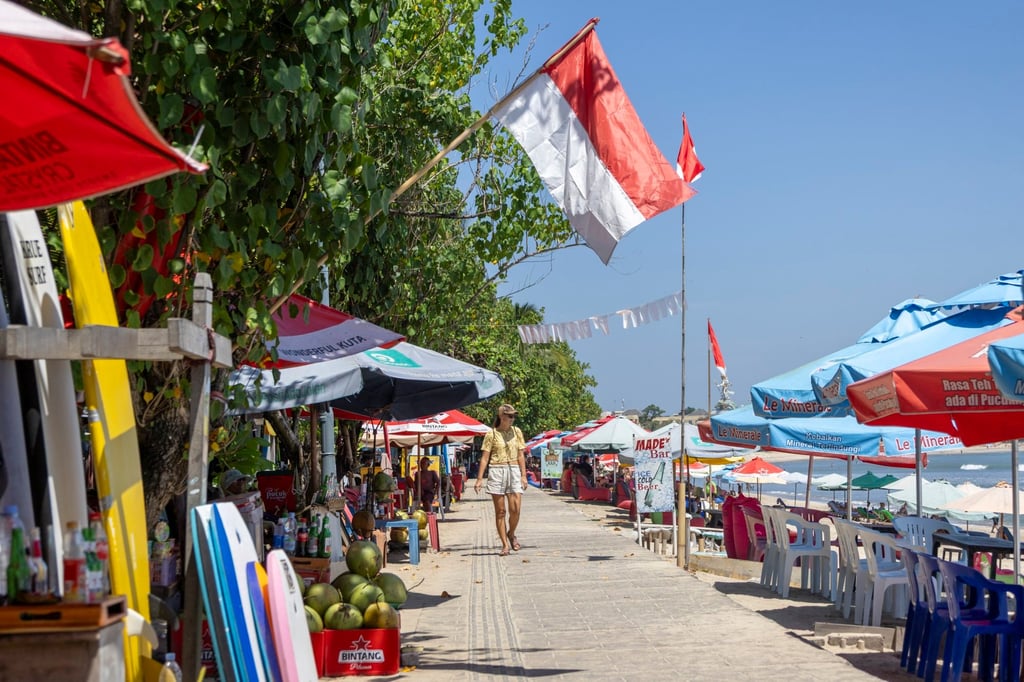 A tourist walks along Kuta beach in Bali, Indonesia, on Tuesday. Tourism leaders and Bali officials have assured travellers that the island is safe to visit. Photo: EPA