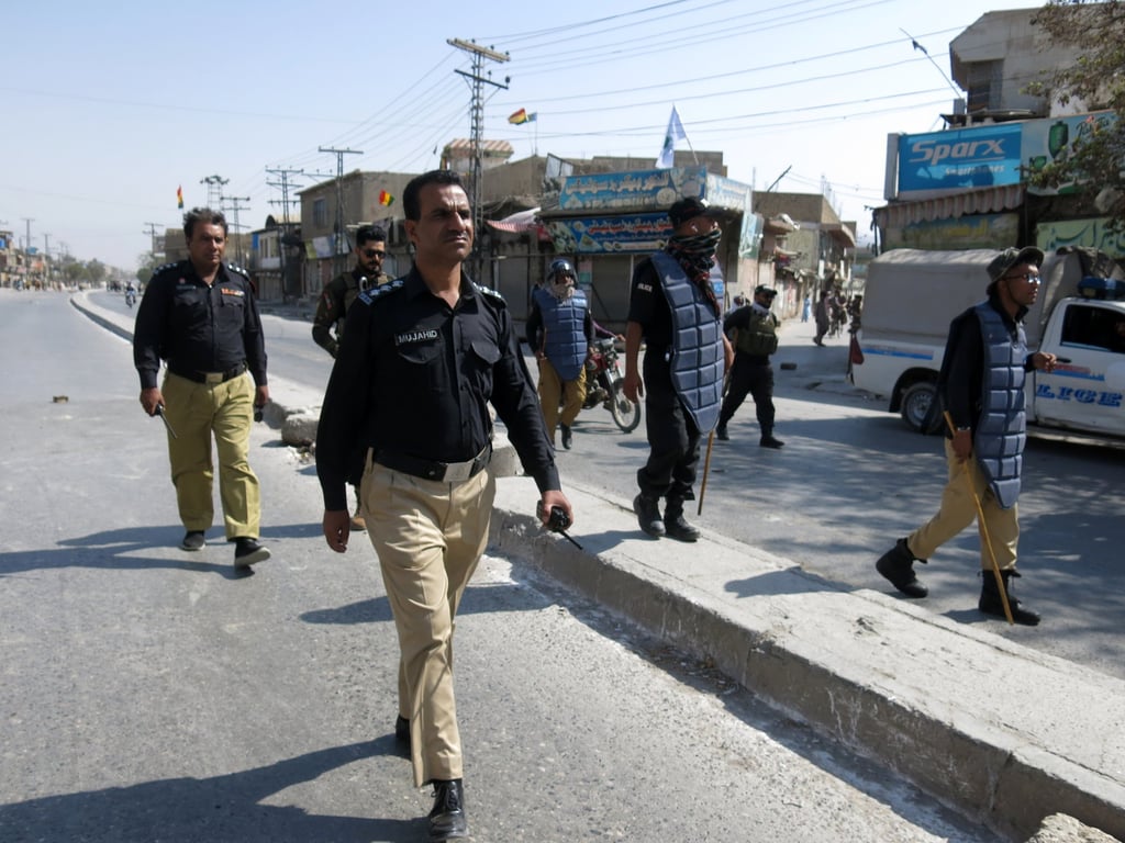 Police patrol after roads were blocked following opposition parties’ call for a strike to condemn the attack on a political rally of Balochistan National Party (BNP) in Quetta on Monday. Photo: EPA