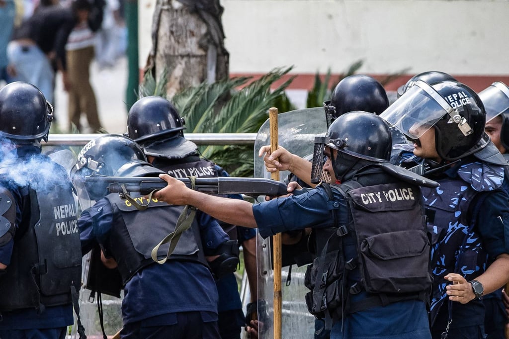 Riot police fire tear gas during a protest outside parliament in Kathmandu on Monday. Photo: AFP Riot police fire tear gas during a protest outside parliament in Kathmandu on Monday. Photo: AFP