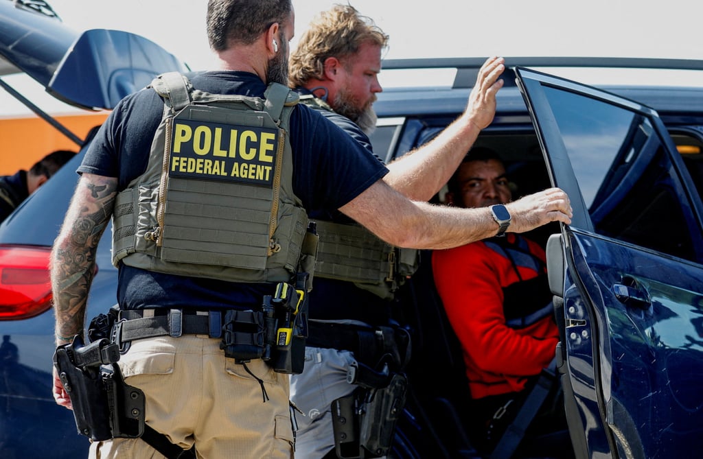 Federal agents detain a migrant near a Home Depot in Chicago. Photo: Reuters Federal agents detain a migrant near a Home Depot in Chicago. Photo: Reuters