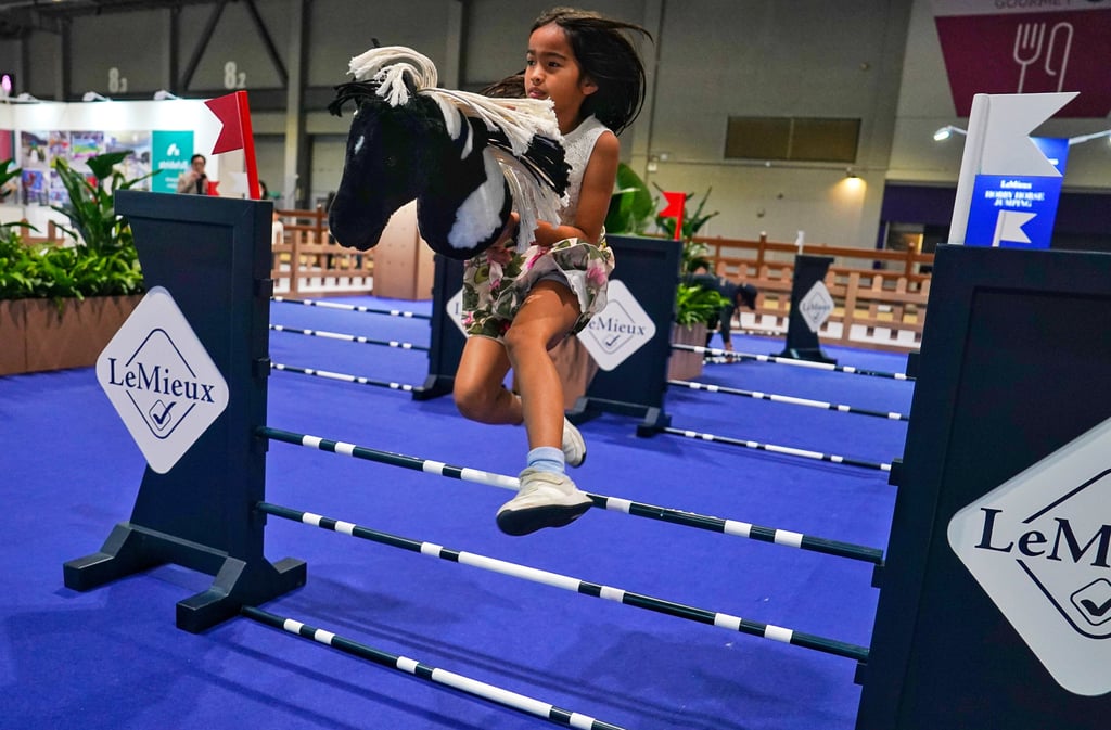Children enjoying the “Hobby Horse Jumping” event at the event this year. Photo: Elson Li