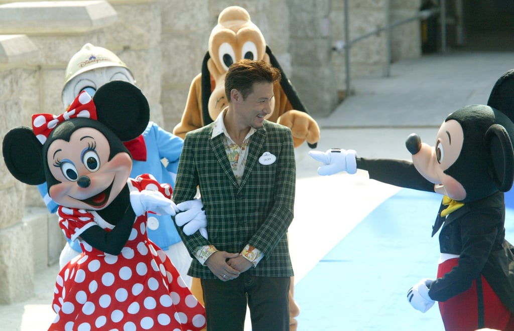 Cantopop singer, actor and Disneyland spokesman Jacky Cheung (centre) attends the Hong Kong Disneyland castle topping ceremony on September 23, 2004. Photo: SCMP Archives