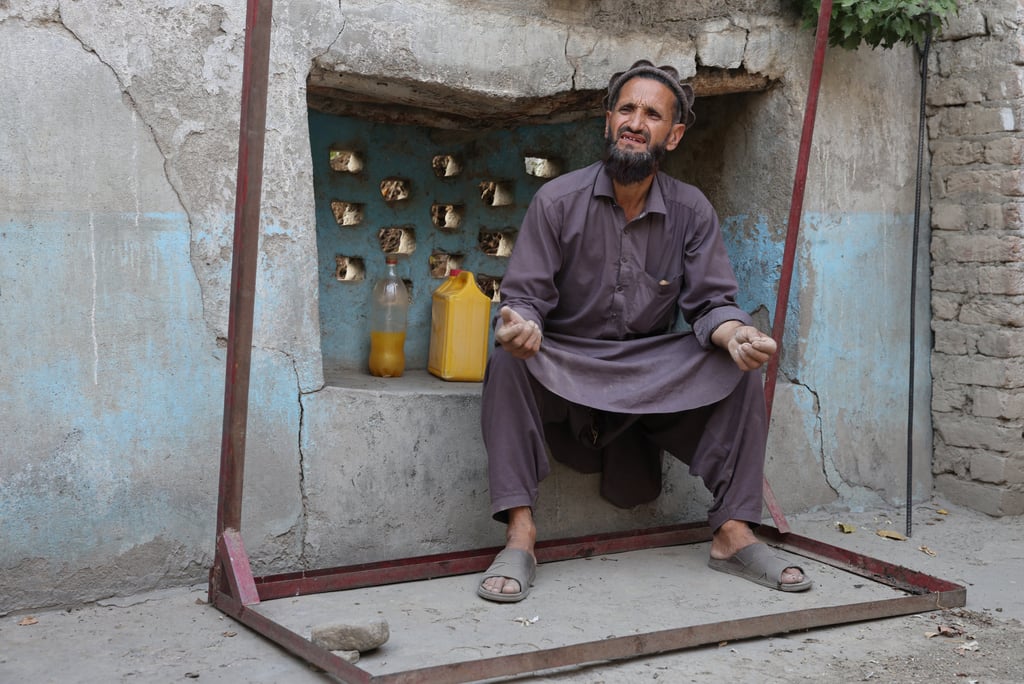 Abdul Ghafar, 52, sits at his partially damaged house on September 6 following a deadly earthquake in Bambakot village in Dera Noor district in Nangarhar province, Afghanistan. Photo: Reuters