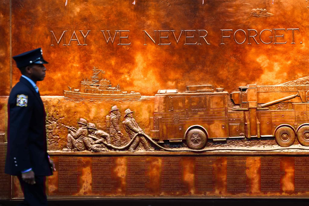 A firefighter walks past an FDNY memorial wall in the World Trade Center area ahead of the 24th anniversary of the September 11 attacks ceremony, in New York on Thursday. Photo: AFP A firefighter walks past an FDNY memorial wall in the World Trade Center area ahead of the 24th anniversary of the September 11 attacks ceremony, in New York on Thursday. Photo: AFP