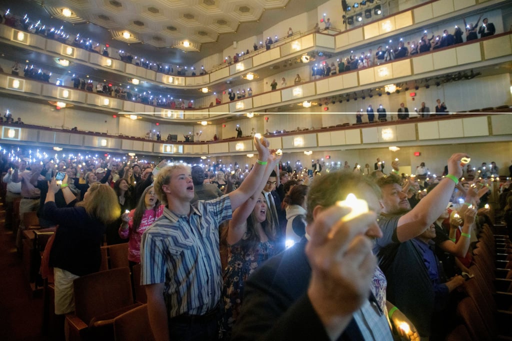 People hold candles and sing during a memorial and prayer vigil for Charlie Kirk at Kennedy Centre on Sunday. Photo: AP People hold candles and sing during a memorial and prayer vigil for Charlie Kirk at Kennedy Centre on Sunday. Photo: AP