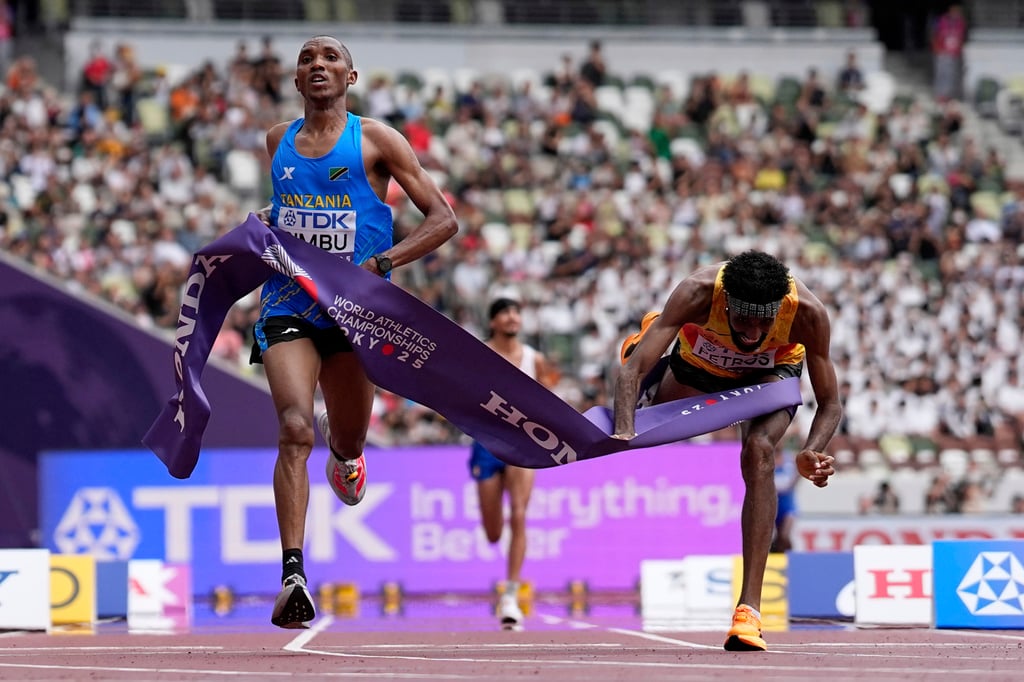 Tanzania’s Alphonce Felix Simbu (left) surges to win gold in the marathon. Photo: AP