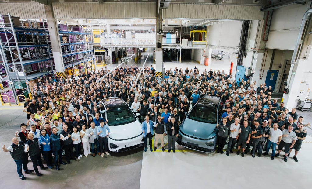 Xpeng and Magna Steyr staff with the first cars made at the Austrian contract manufacturer’s plant in Graz. Photo: Handout
